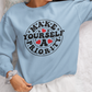 A person wearing a light blue unisex sweatshirt with the text 'MAKE YOURSELF A PRIORITY' printed on the front.
