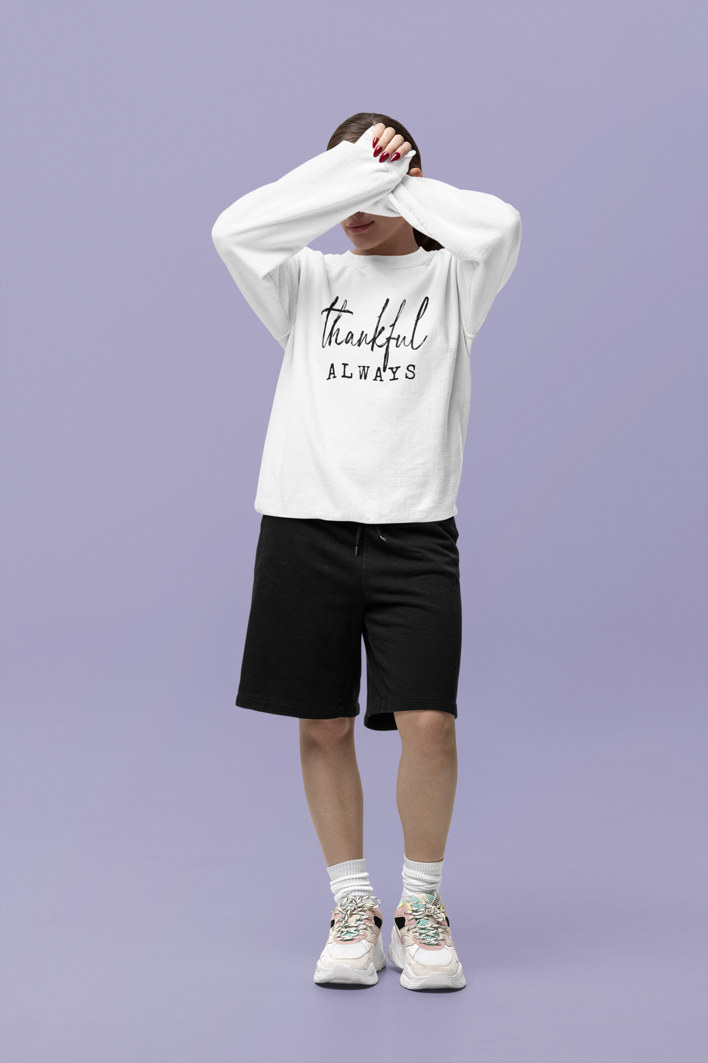Person wearing a white sweatshirt with 'thankful ALWAYS' text on a purple background