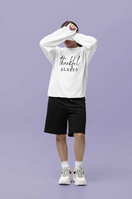 Person wearing a white sweatshirt with 'thankful ALWAYS' text on a purple background