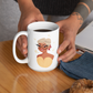 mockup of a tattooed woman holding a 15-oz scorpio mug