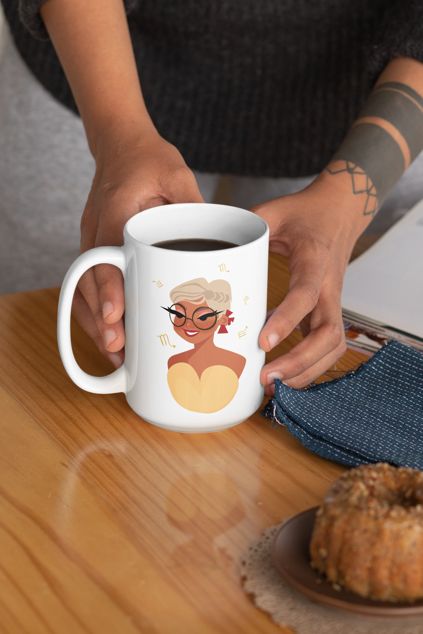 mockup of a tattooed woman holding a 15-oz scorpio mug